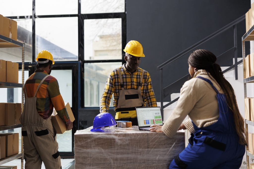warehouse managers checking order information laptop screen prepare parcel delivery storehouse managers team looking purchase list computer preparing packages delivery scaled